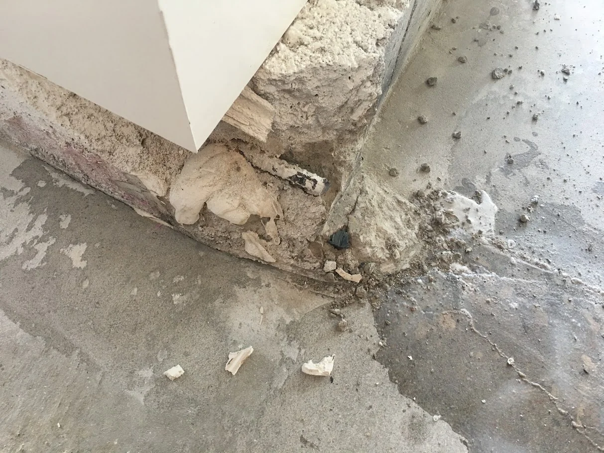 Before: Busted Floor Corner